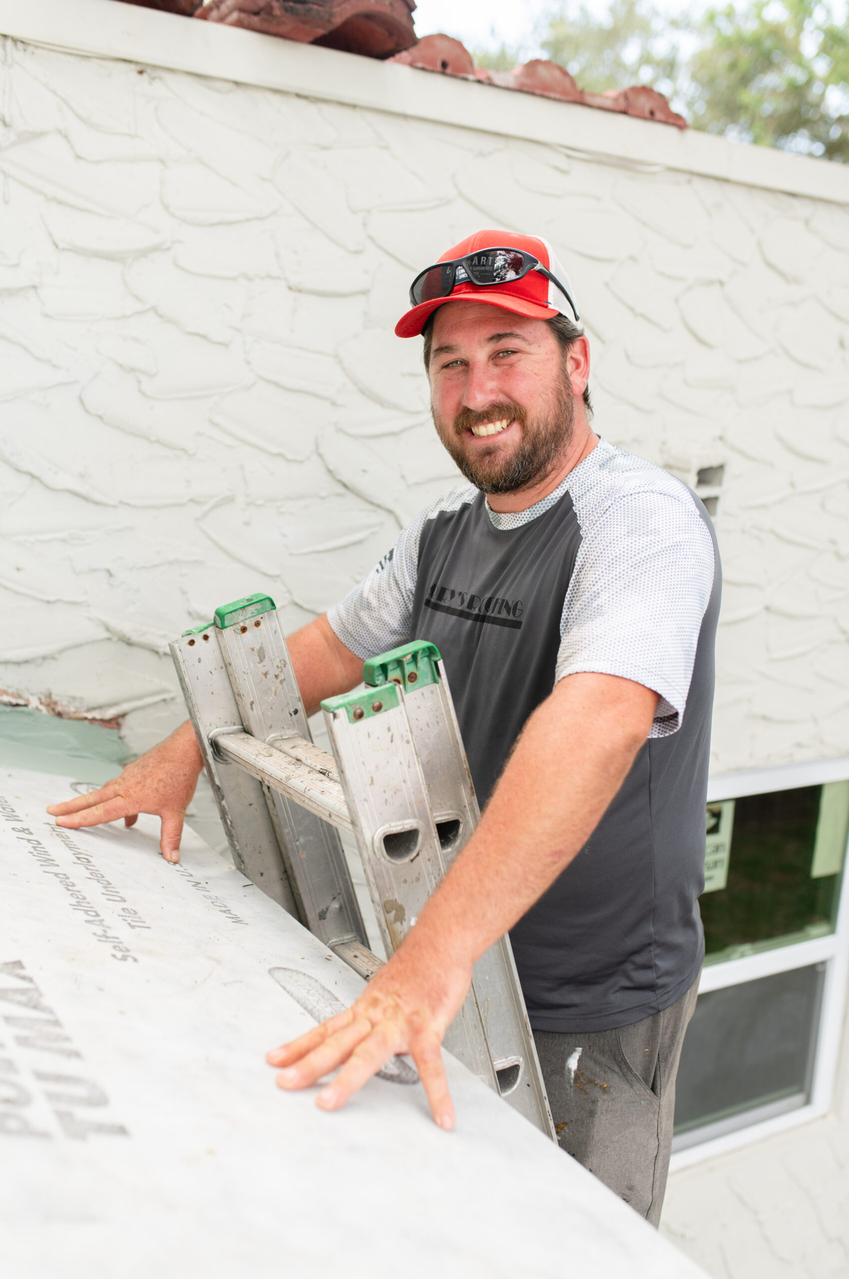 Roof maintenance man on ladder